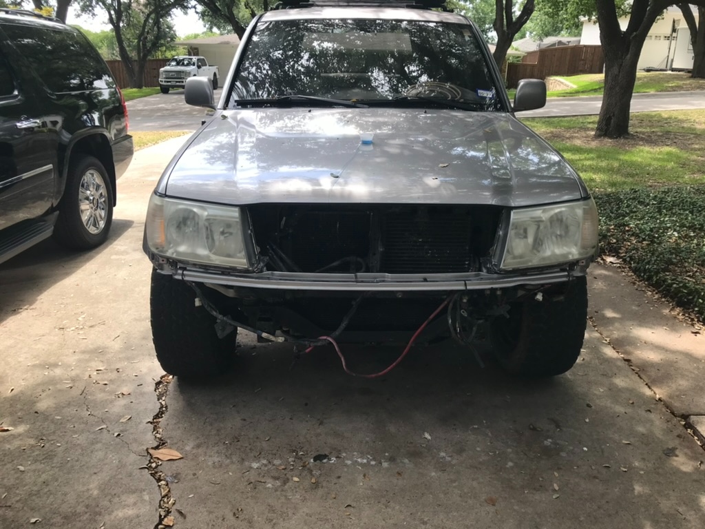 Front clip removed and headlights out for service